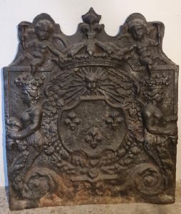 Decorated cast iron fireplace plate